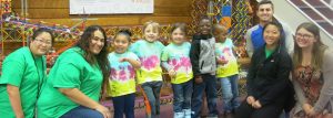 volunteers with children on a field trip