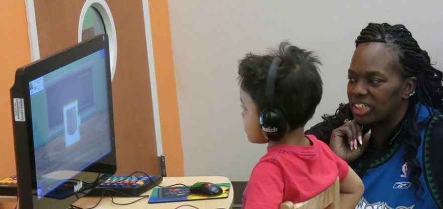 student and teacher looking at computer screen