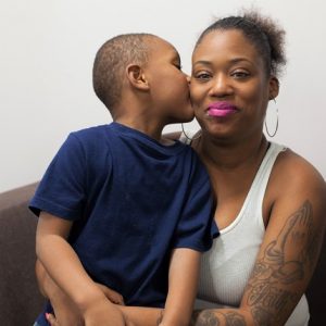 young son kissing mom on her cheek